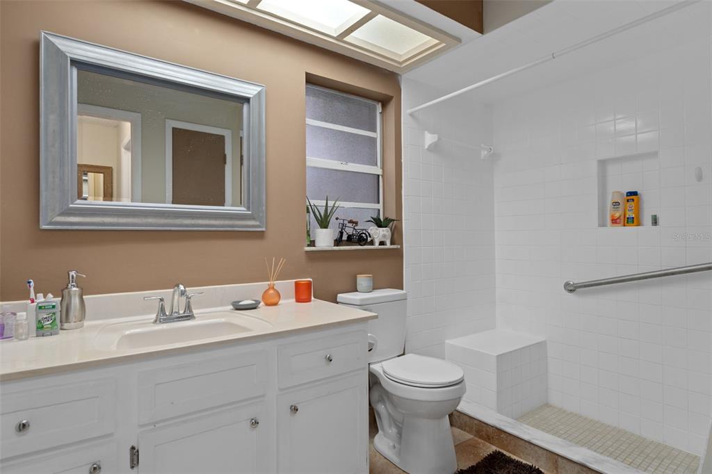 4355 Goldcoast Avenue Spring Hill, FL 34609 - Photo 17 of 30 a bathroom with a sink mirror vanity and toilet