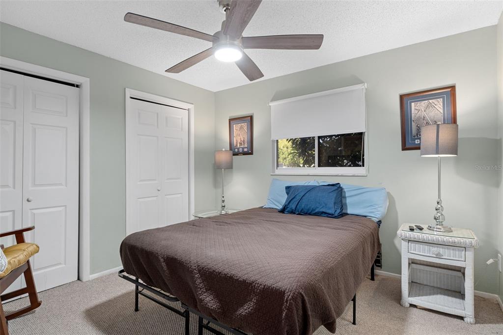 4355 Goldcoast Avenue Spring Hill, FL 34609 - Photo 19 of 30 a bedroom with a bed a mirror on dresser and a flat screen tv