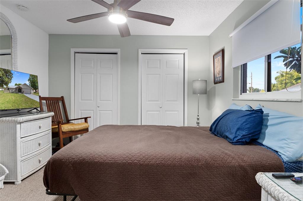 4355 Goldcoast Avenue Spring Hill, FL 34609 - Photo 20 of 30 a bedroom with a bed and a chandelier