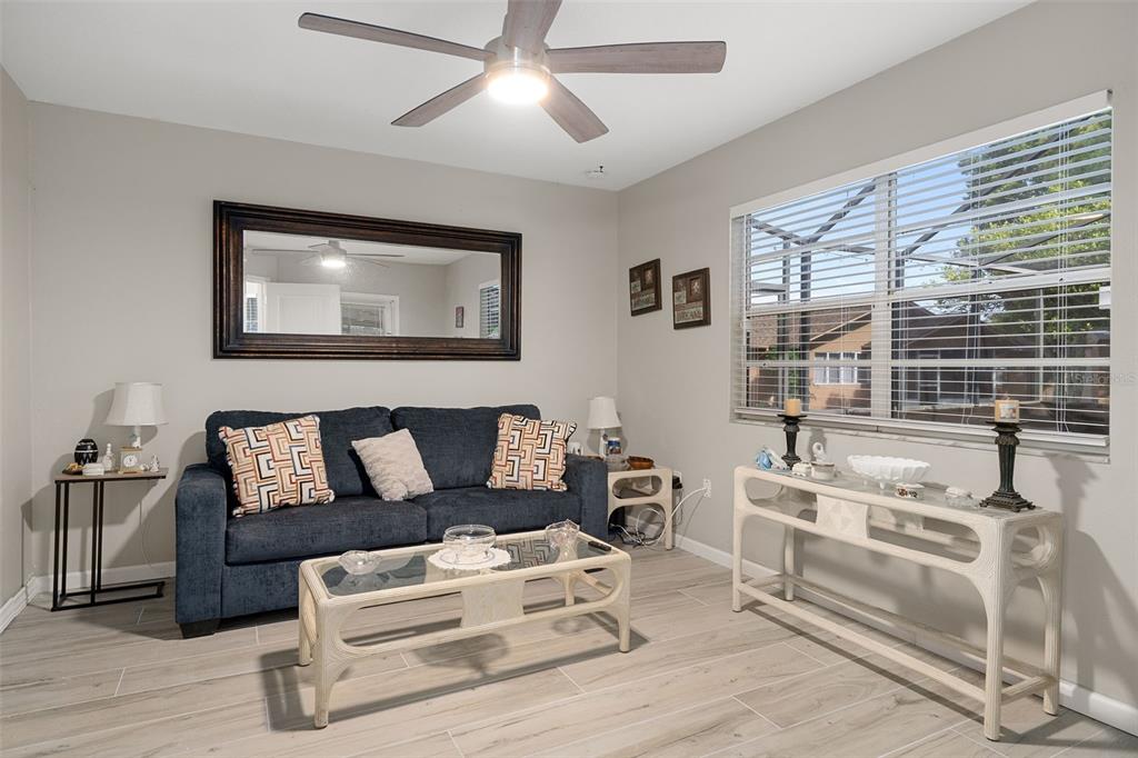 4355 Goldcoast Avenue Spring Hill, FL 34609 - Photo 22 of 30 a living room with furniture and a large window