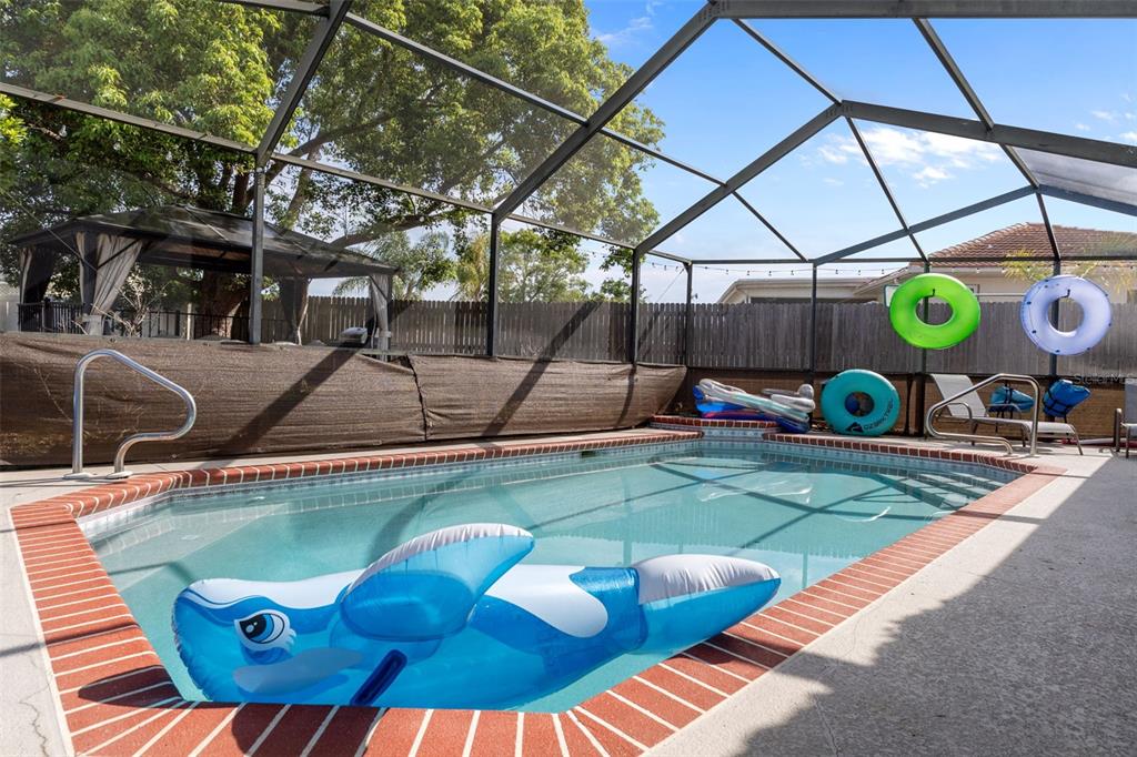 4355 Goldcoast Avenue Spring Hill, FL 34609 - Photo 26 of 30 a view of a swimming pool with a patio