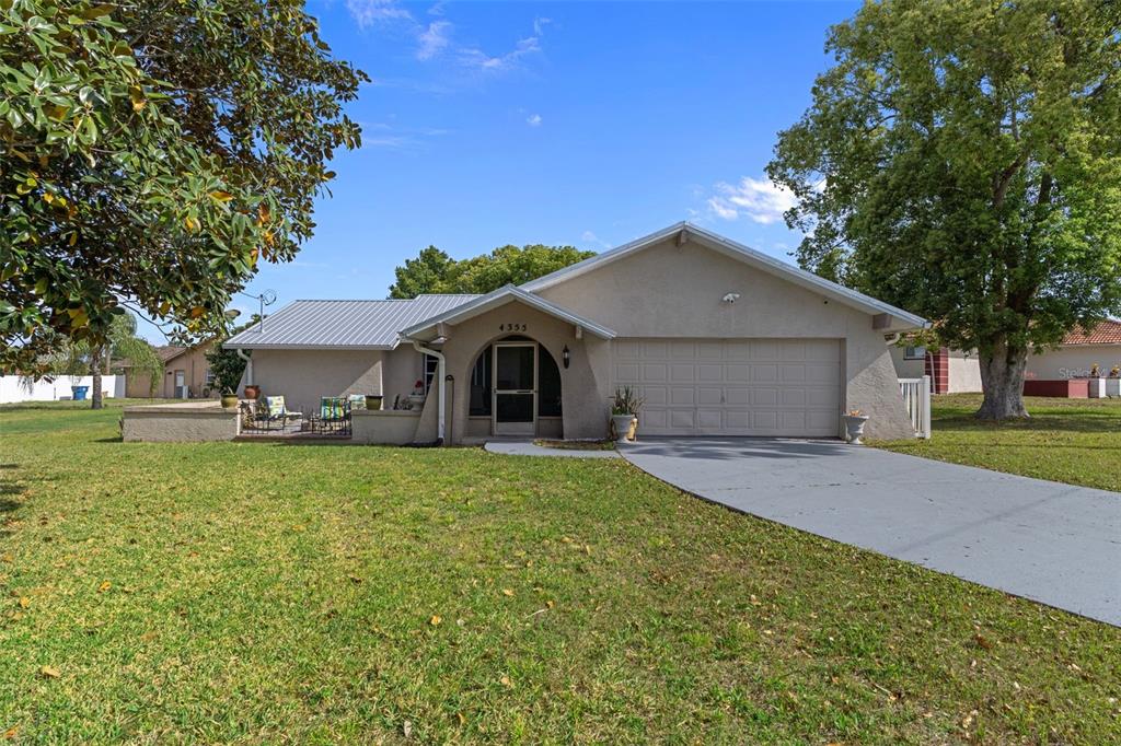 4355 Goldcoast Avenue Spring Hill, FL 34609 - Photo 4 of 30 a front view of a house with garden