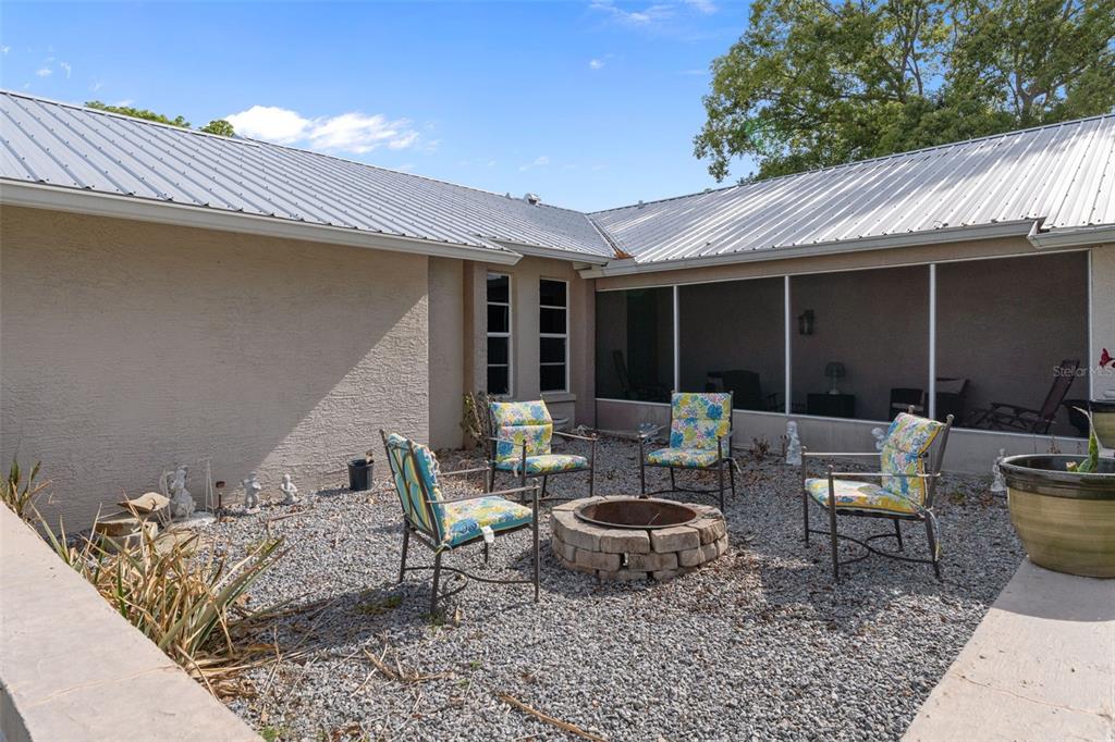 4355 Goldcoast Avenue Spring Hill, FL 34609 - Photo 5 of 30 a backyard of a house with outdoor seating