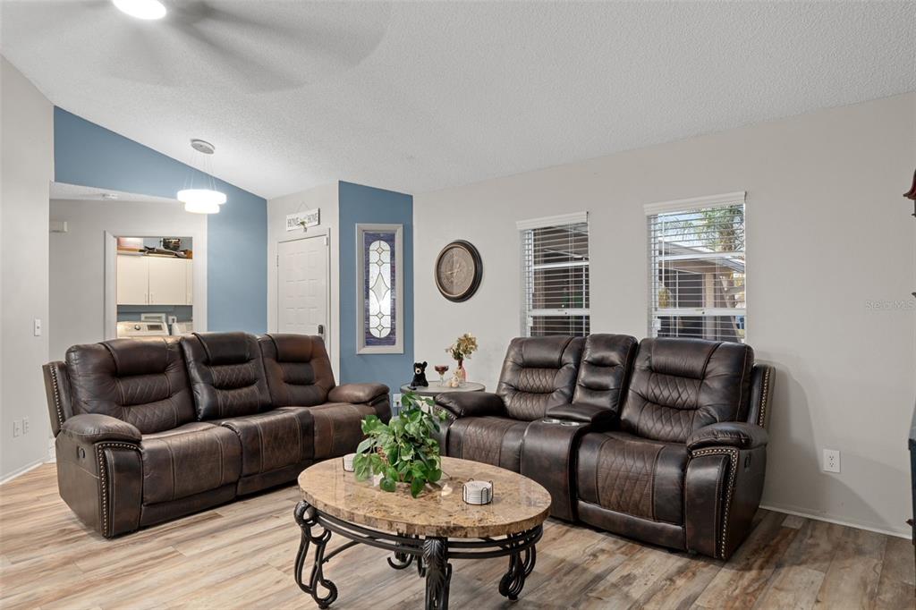 4355 Goldcoast Avenue Spring Hill, FL 34609 - Photo 8 of 30 a living room with furniture potted plant and wooden floor