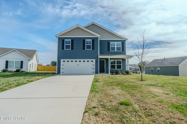 a front view of a house with a yard