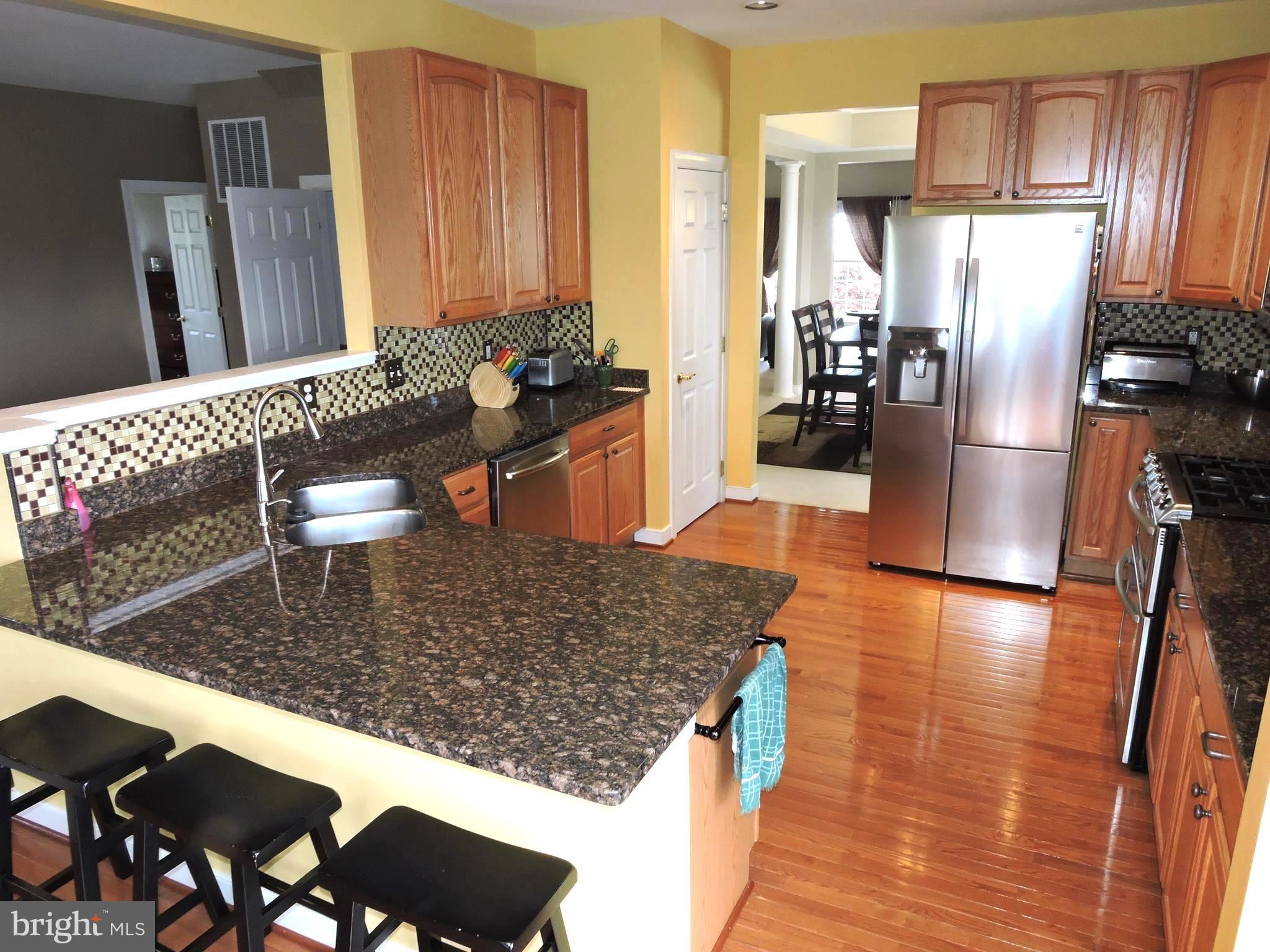 34 Wabash Road Inwood, WV 25428 - Photo 8 of 30 a kitchen with stainless steel appliances granite countertop a refrigerator and a stove