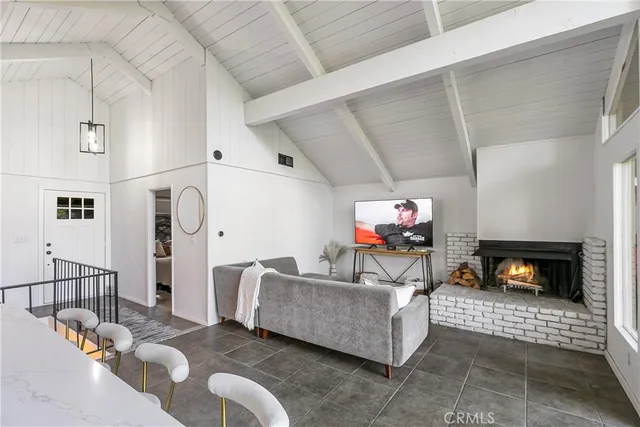 a kitchen with stainless steel appliances kitchen island granite countertop a table chairs and a refrigerator