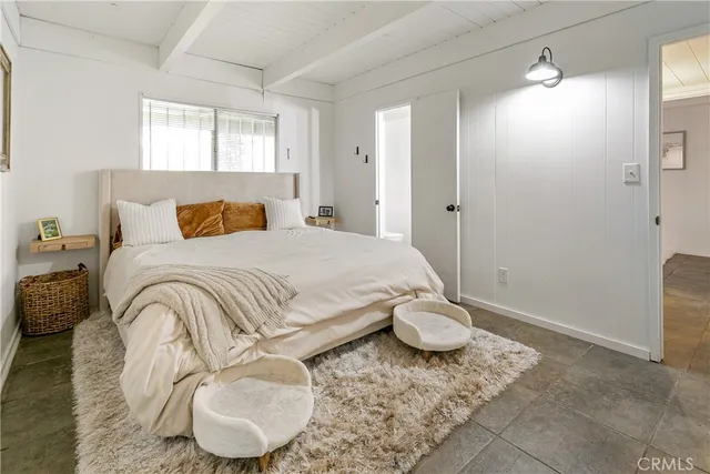 a room with lots of wooden furniture and windows