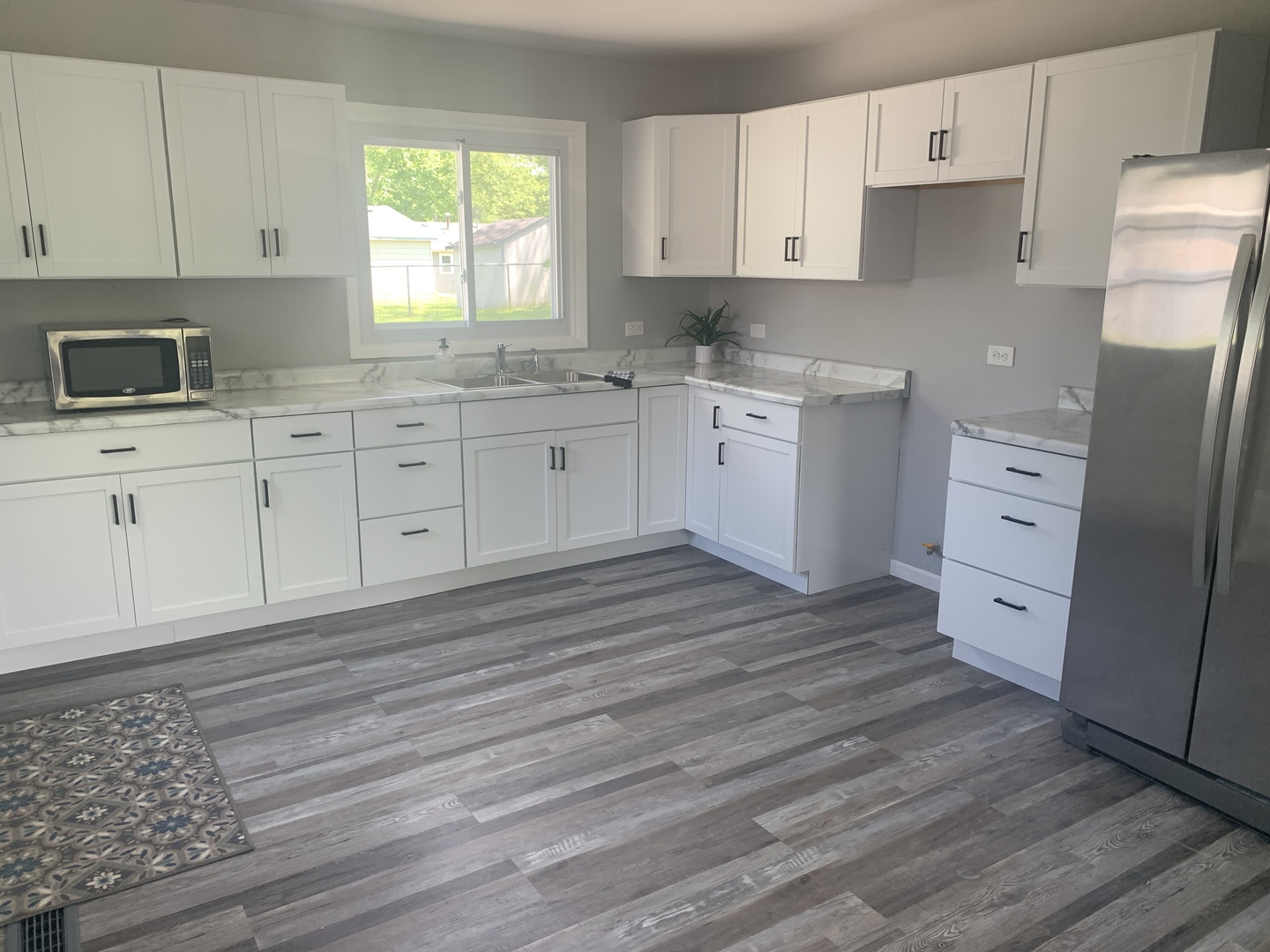 305 Tiverton Lane Steger, IL 60475 - Photo 5 of 13 a kitchen with cabinets appliances a sink and a window