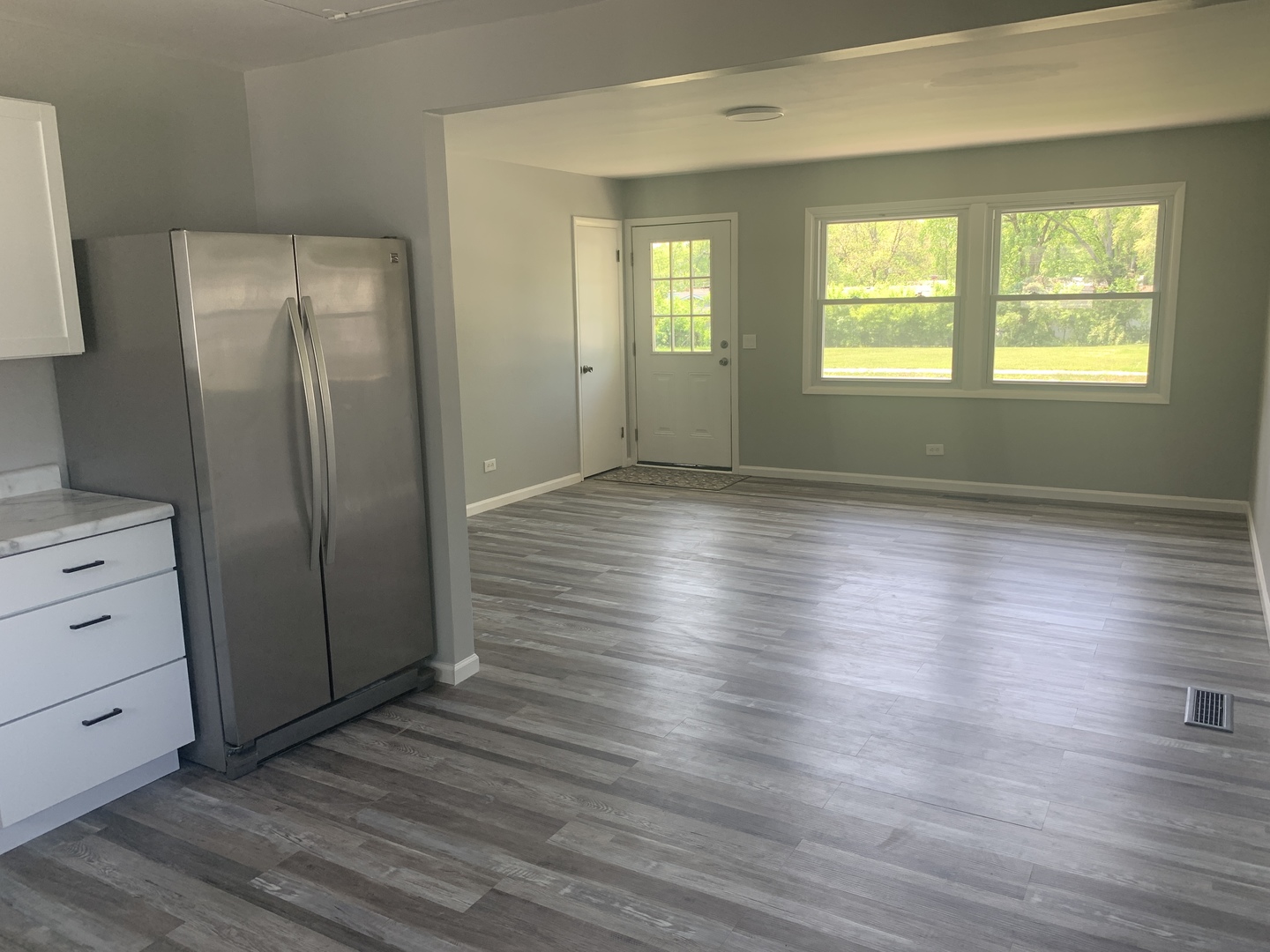 305 Tiverton Lane Steger, IL 60475 - Photo 6 of 13 an empty room with wooden floor and windows