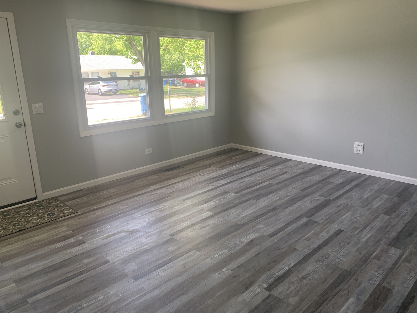305 Tiverton Lane Steger, IL 60475 - Photo 10 of 13 an empty room with wooden floor and windows