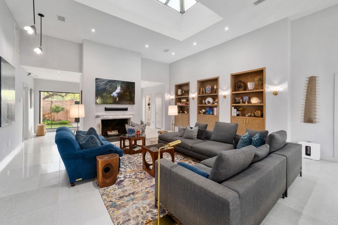 a living room with furniture a fireplace and a flat screen tv