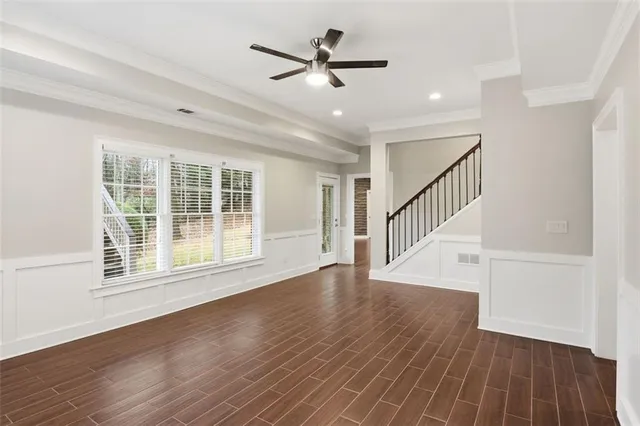 a view of empty room with wooden floor and window