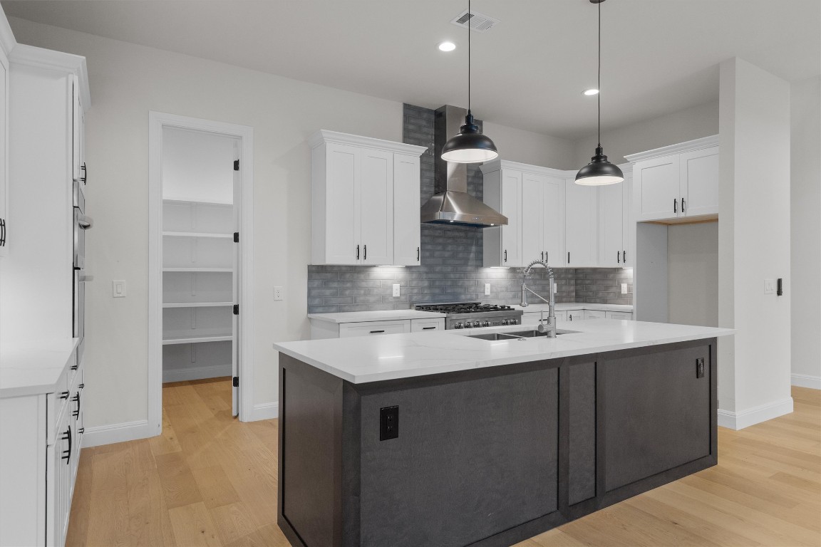 7705 Calcutta Run Drive Jonestown, TX 78645 - Photo 11 of 40 a kitchen with kitchen island a sink stainless steel appliances and cabinets