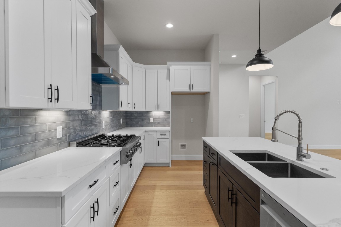 7705 Calcutta Run Drive Jonestown, TX 78645 - Photo 12 of 40 a kitchen with stainless steel appliances a sink a stove top oven a counter space and cabinets