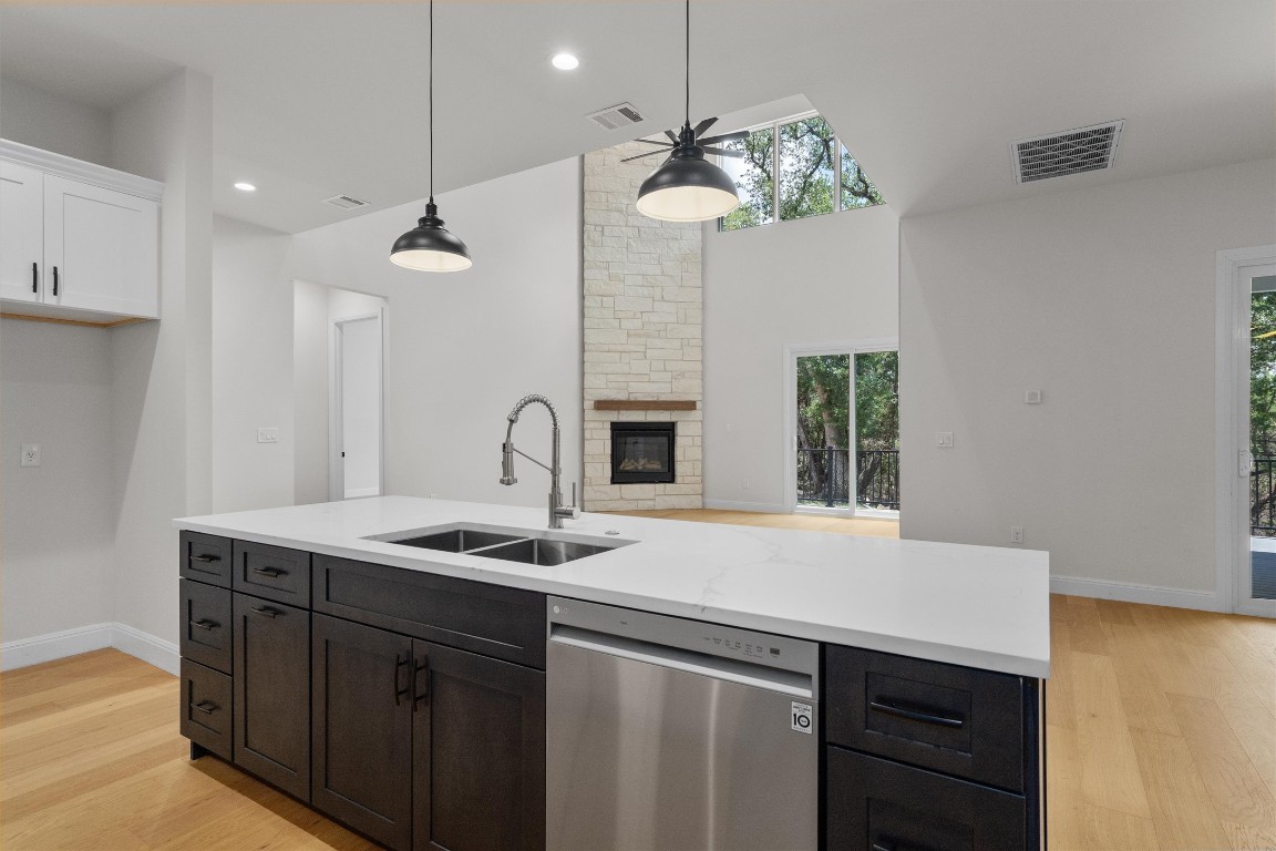 7705 Calcutta Run Drive Jonestown, TX 78645 - Photo 14 of 40 a kitchen with a sink and a stove