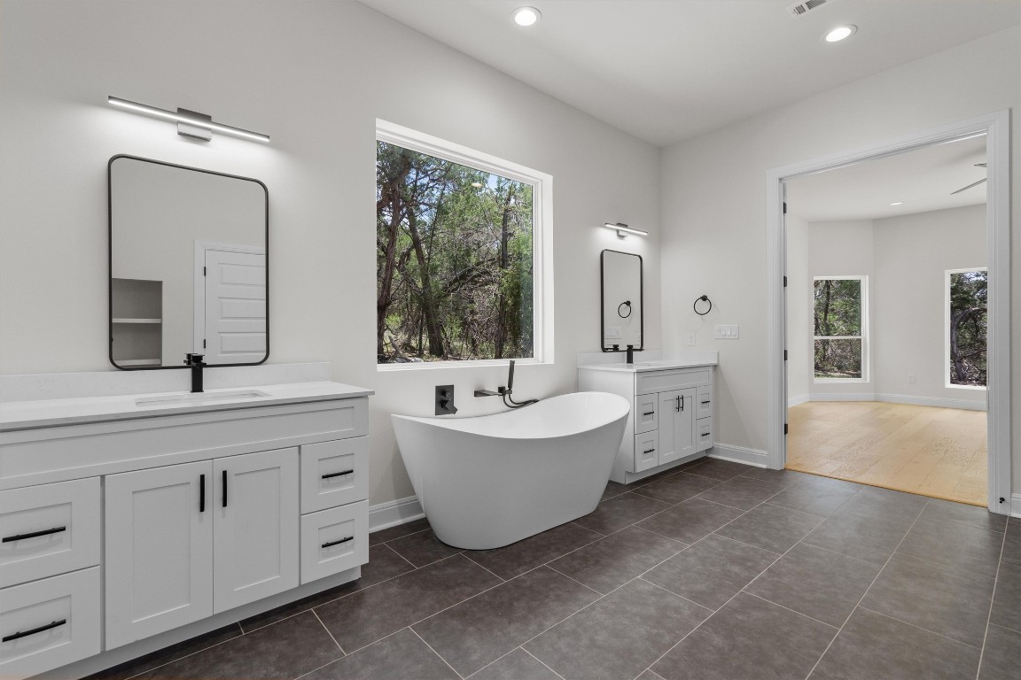 7705 Calcutta Run Drive Jonestown, TX 78645 - Photo 19 of 40 a spacious bathroom with 2 bathtub windows and sink