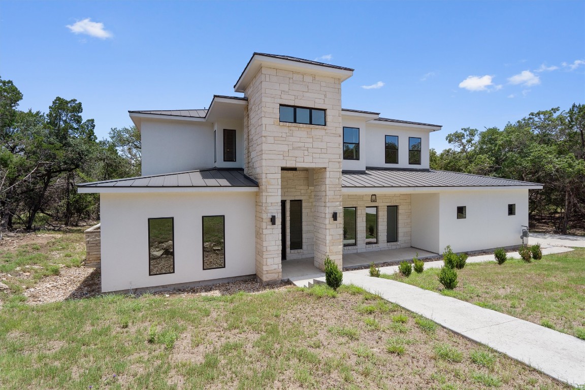 7705 Calcutta Run Drive Jonestown, TX 78645 - Photo 2 of 40 a front view of a house with garden