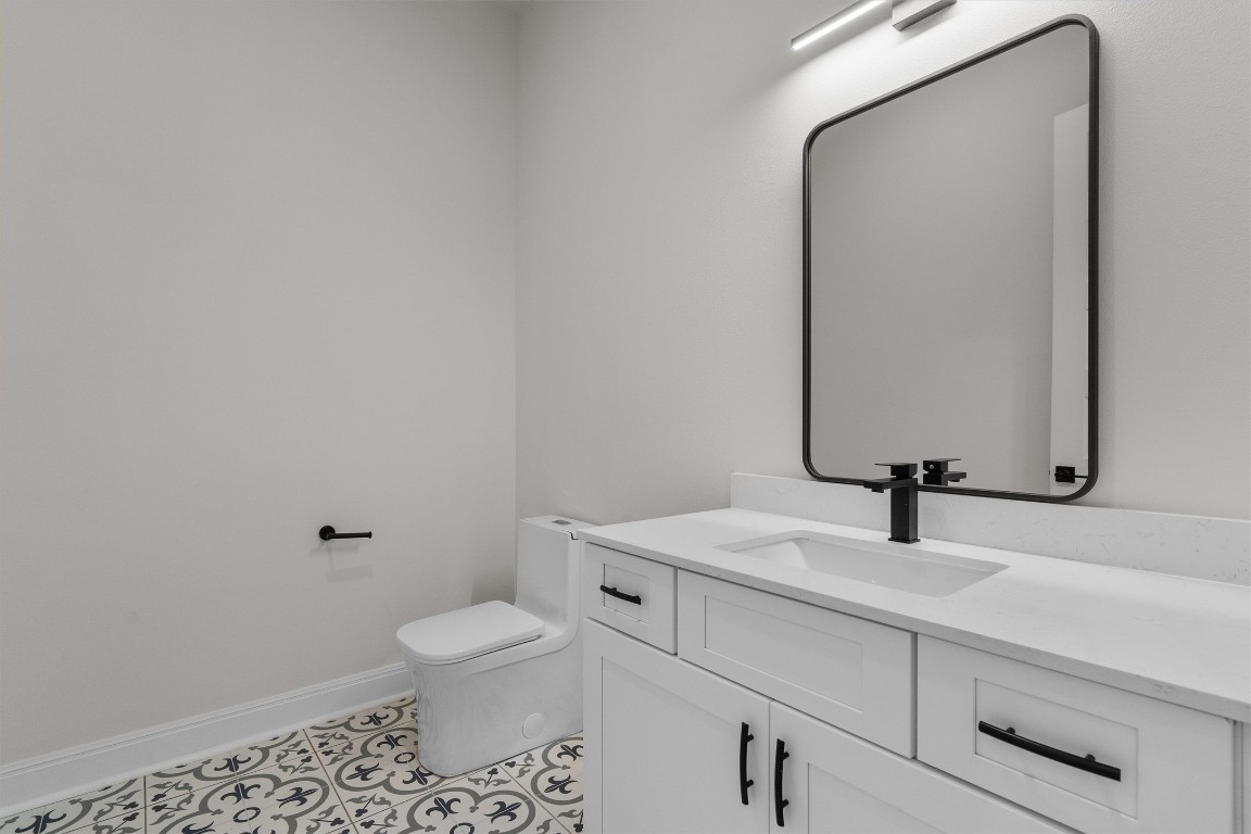 7705 Calcutta Run Drive Jonestown, TX 78645 - Photo 21 of 40 a bathroom with a sink a toilet and mirror