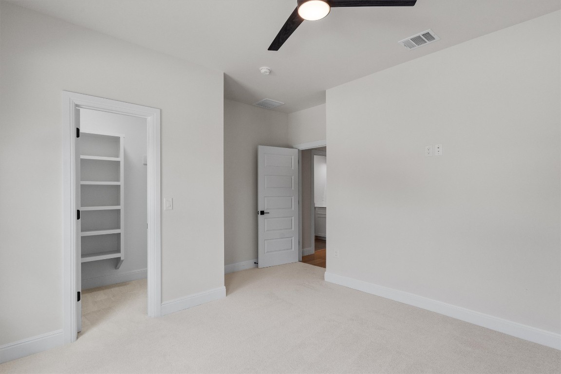 7705 Calcutta Run Drive Jonestown, TX 78645 - Photo 27 of 40 an empty room with closet and windows