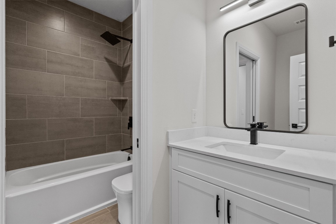 7705 Calcutta Run Drive Jonestown, TX 78645 - Photo 28 of 40 a bathroom with a sink a toilet and a bathtub