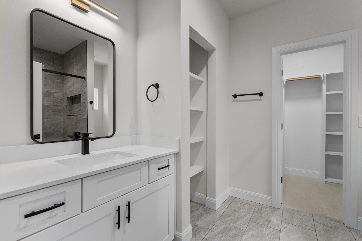 7705 Calcutta Run Drive Jonestown, TX 78645 - Photo 30 of 40 a bathroom with a sink and a mirror