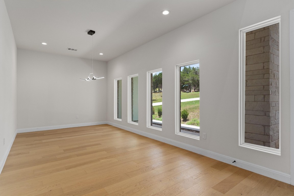 7705 Calcutta Run Drive Jonestown, TX 78645 - Photo 3 of 40 an empty room with windows and entrance