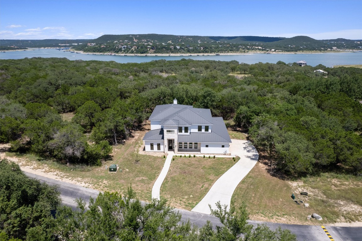 7705 Calcutta Run Drive Jonestown, TX 78645 - Photo 37 of 40 an aerial view of a house with a garden and lake view