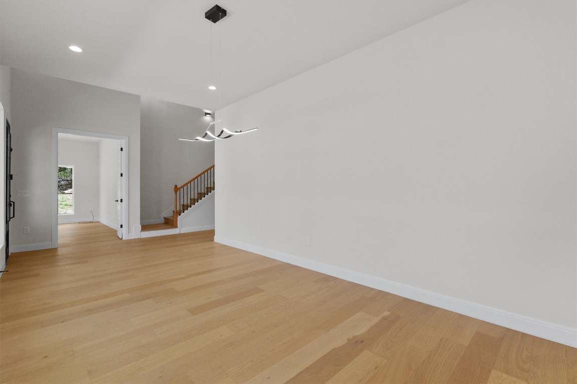 7705 Calcutta Run Drive Jonestown, TX 78645 - Photo 4 of 40 a view of a room with wooden floor and a ceiling fan