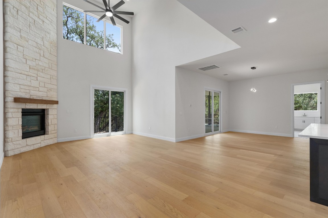 7705 Calcutta Run Drive Jonestown, TX 78645 - Photo 6 of 40 an empty room with windows and fireplace