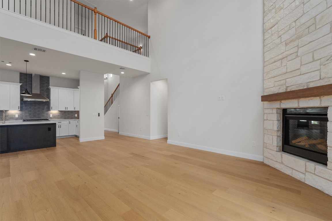 7705 Calcutta Run Drive Jonestown, TX 78645 - Photo 7 of 40 a view of an empty room with a fireplace
