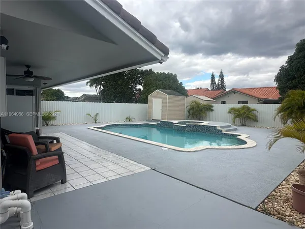 an aerial view of a house with swimming pool