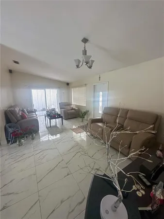 a living room with furniture a air conditioner and a window