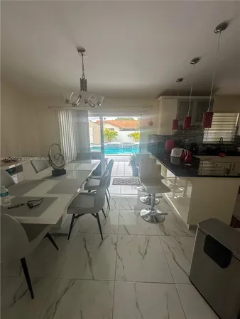 a kitchen with stainless steel appliances kitchen island granite countertop a sink and cabinets