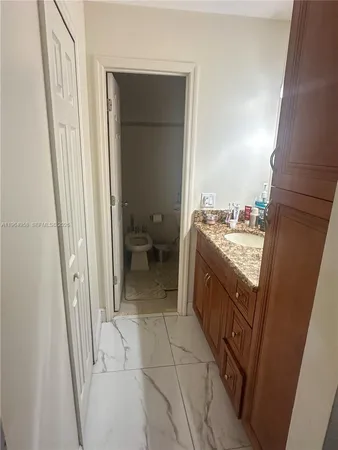 a bathroom with a sink a toilet and a shower