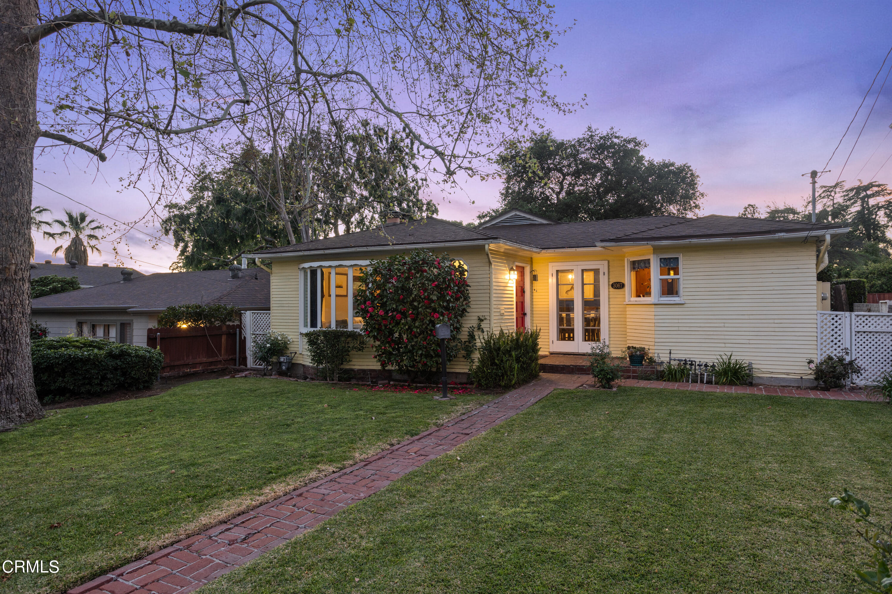 a front view of a house with a garden