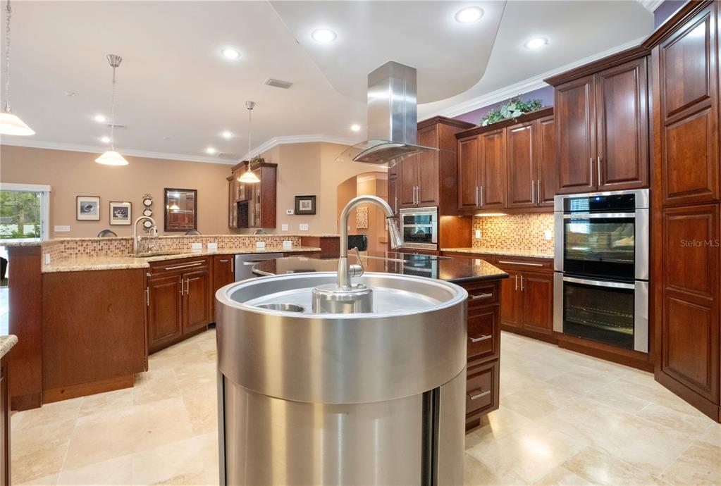 5785 Gilliam Road Orlando, FL 32818 - Photo 23 of 100 a kitchen with stainless steel appliances granite countertop a sink a stove and a refrigerator