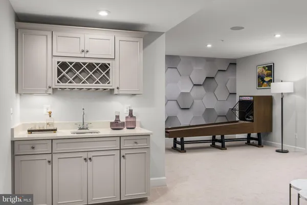 a kitchen with white cabinets and a sink