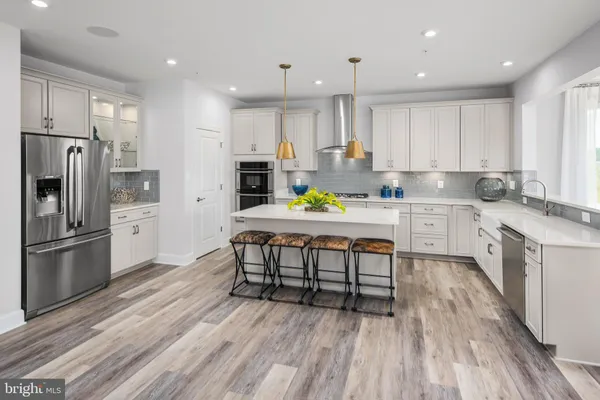 a kitchen with a sink appliances and cabinets