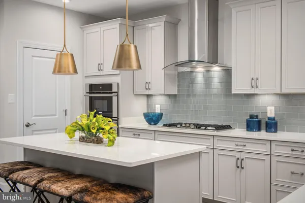 a kitchen with a sink a stove and cabinets
