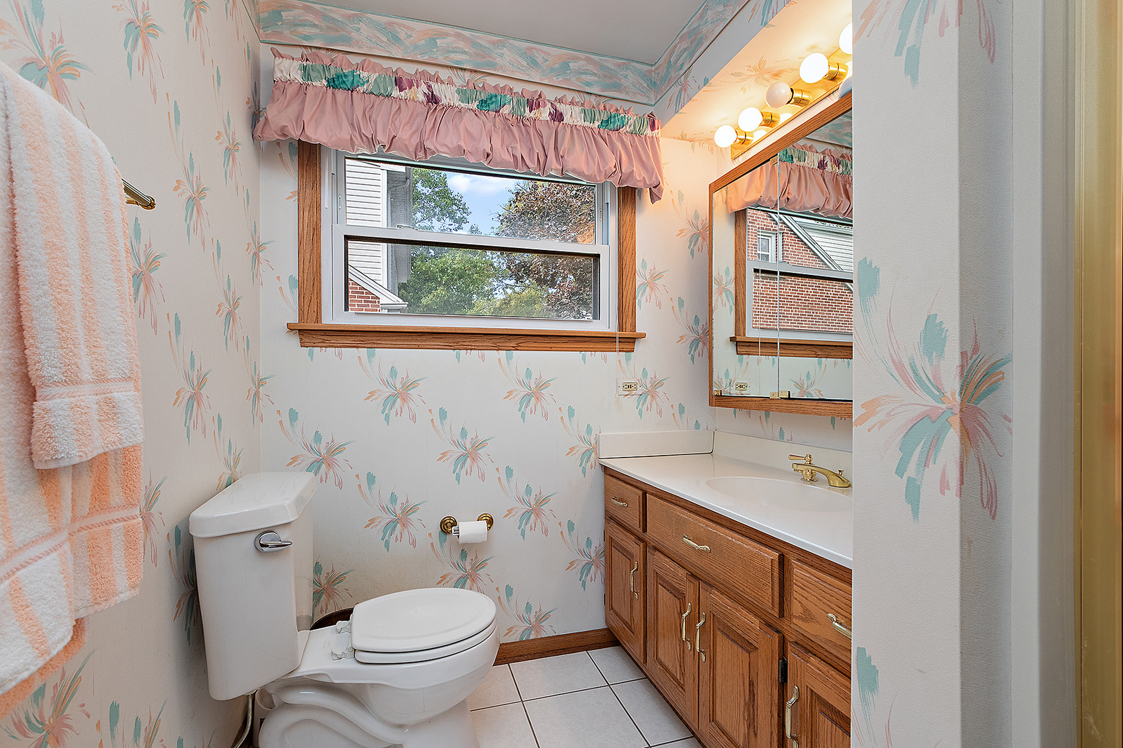 1352 Evergreen Road Homewood, IL 60430 - Photo 18 of 32 a bathroom with a sink a toilet and a window