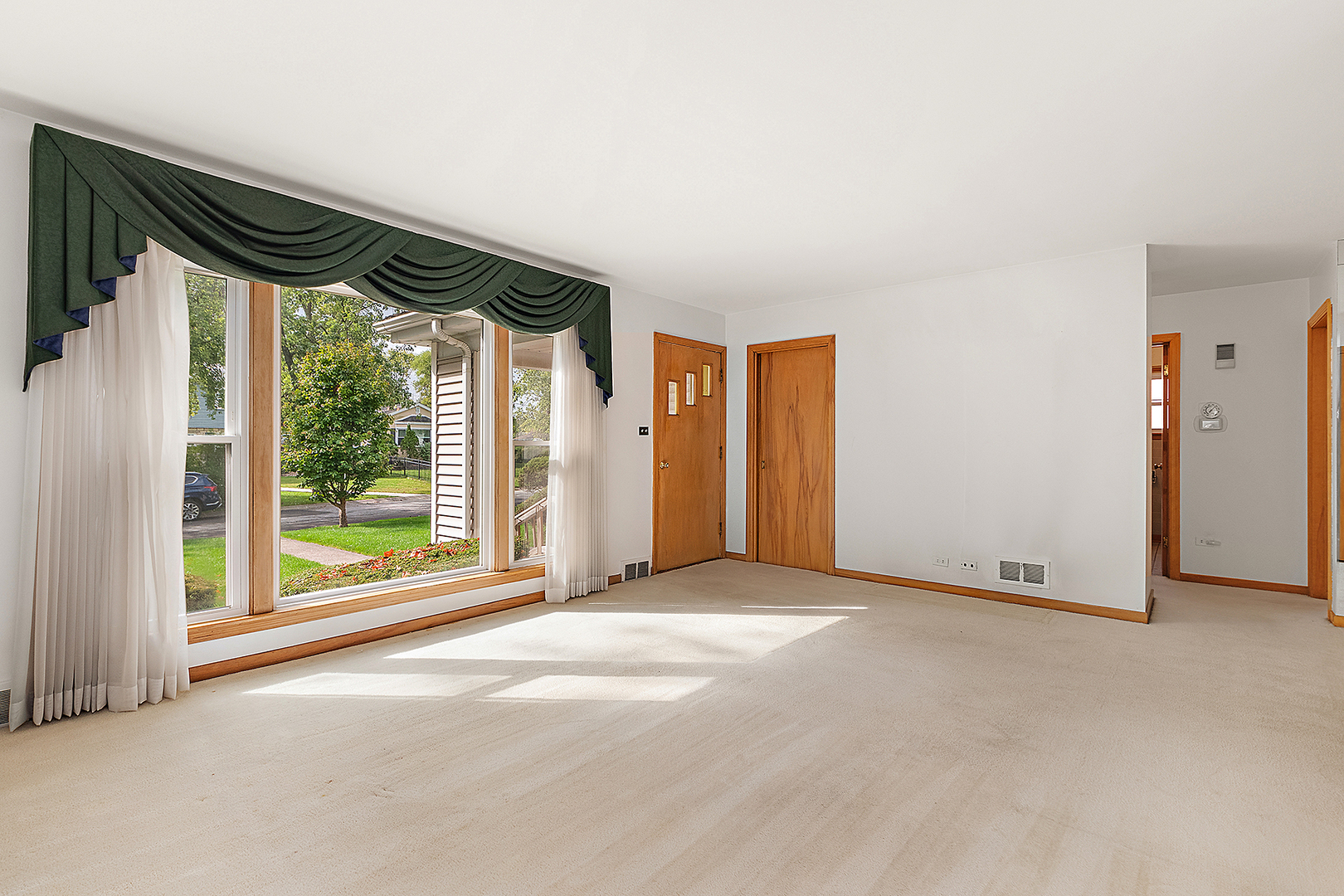 1352 Evergreen Road Homewood, IL 60430 - Photo 5 of 32 a view of a room with wooden floor and a large window