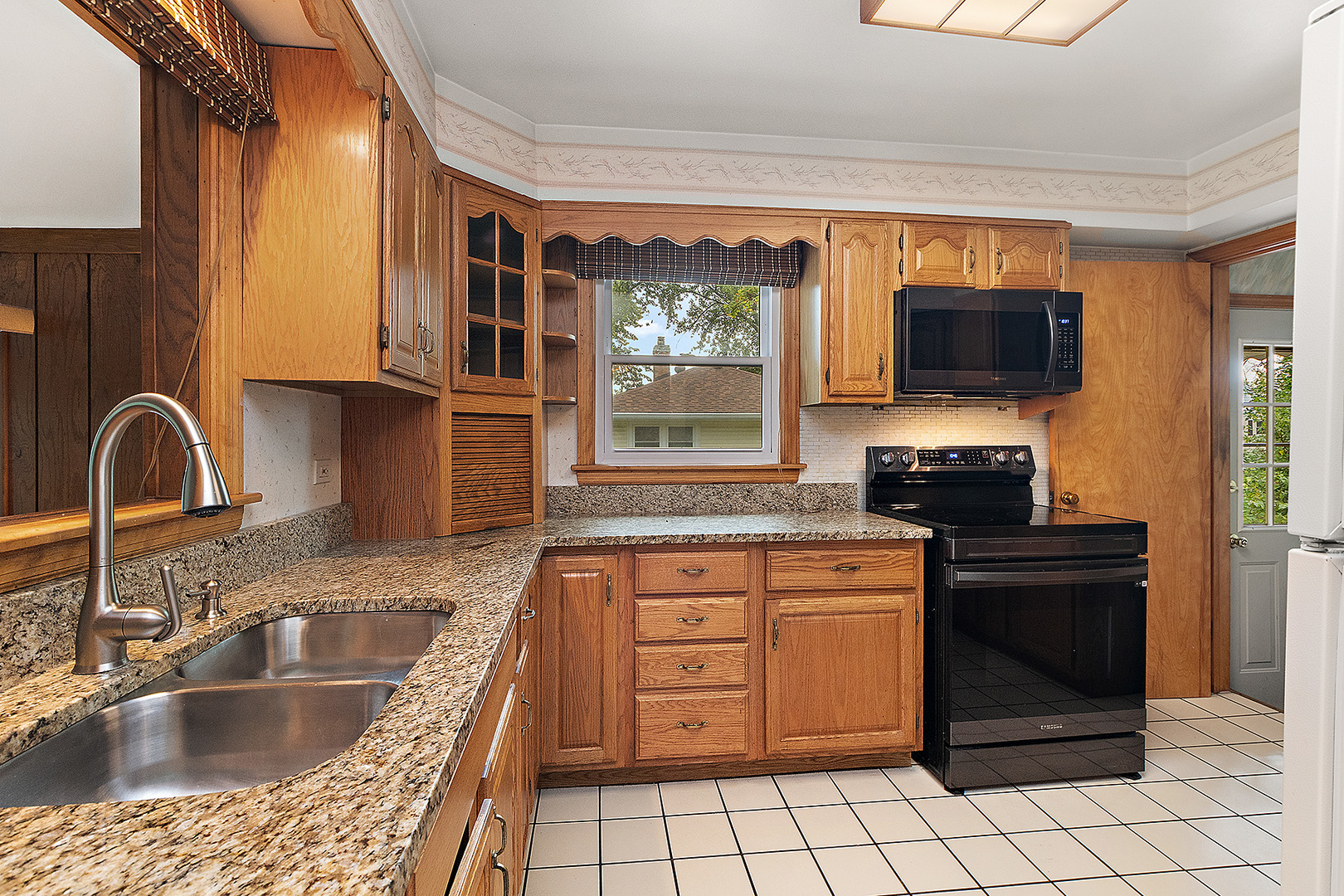 1352 Evergreen Road Homewood, IL 60430 - Photo 7 of 32 a kitchen with a stove a sink and a microwave