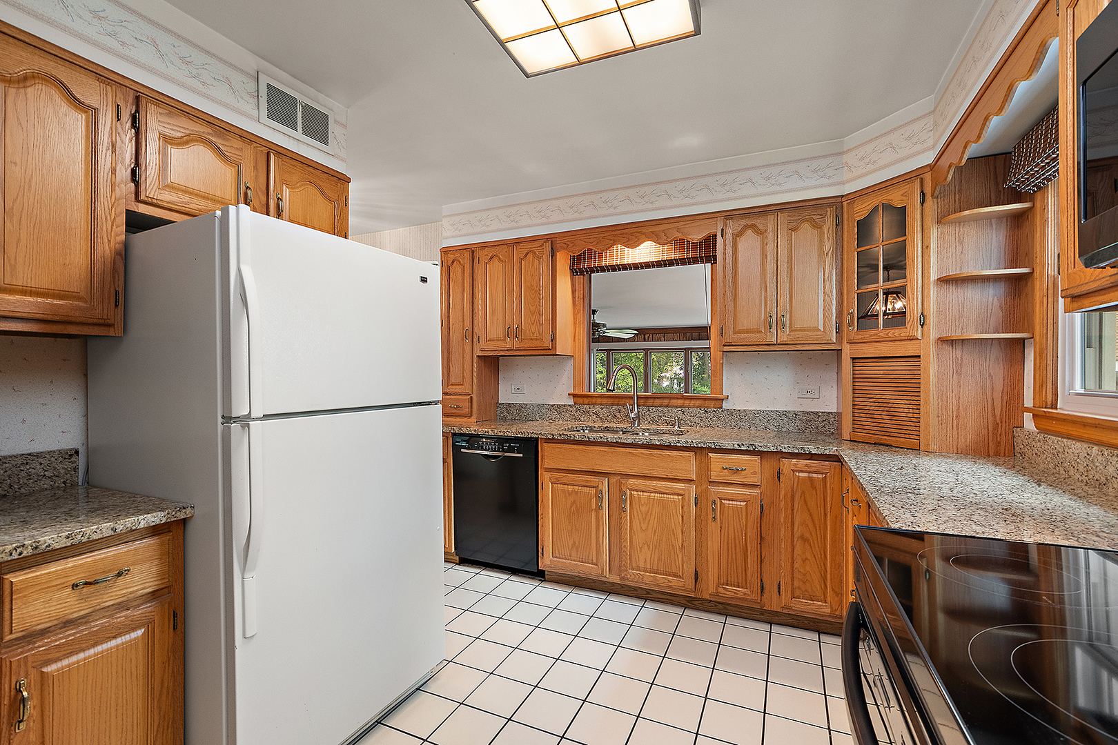 1352 Evergreen Road Homewood, IL 60430 - Photo 8 of 32 a kitchen with stainless steel appliances granite countertop a refrigerator sink and stove