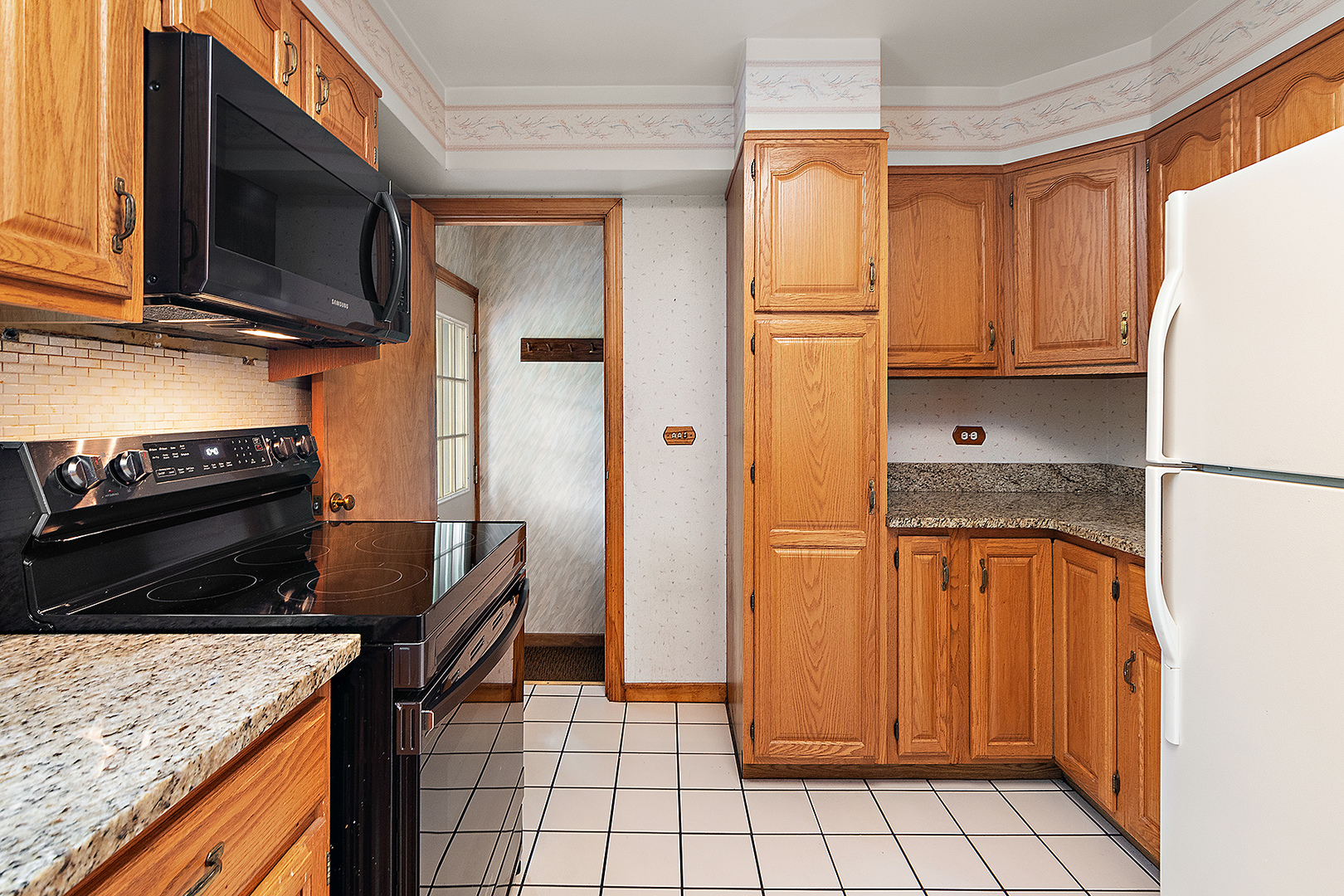 1352 Evergreen Road Homewood, IL 60430 - Photo 9 of 32 a kitchen with stainless steel appliances granite countertop a refrigerator sink and stove