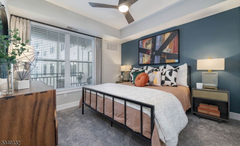 100 Union Street, Unit 429 Elizabeth, NJ 07202 - Photo 27 of 41 a bed sitting in a bedroom next to a window