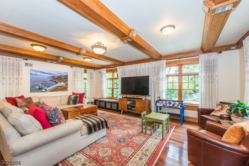 89 Ridgewood Avenue Glen Ridge, NJ 07028 - Photo 11 of 21 a living room with furniture and a flat screen tv