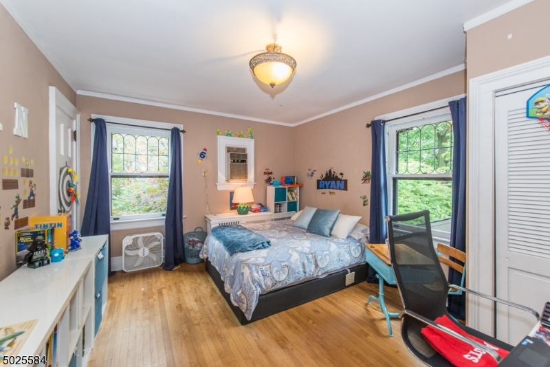 89 Ridgewood Avenue Glen Ridge, NJ 07028 - Photo 16 of 21 a bedroom with a bed and a wooden floor