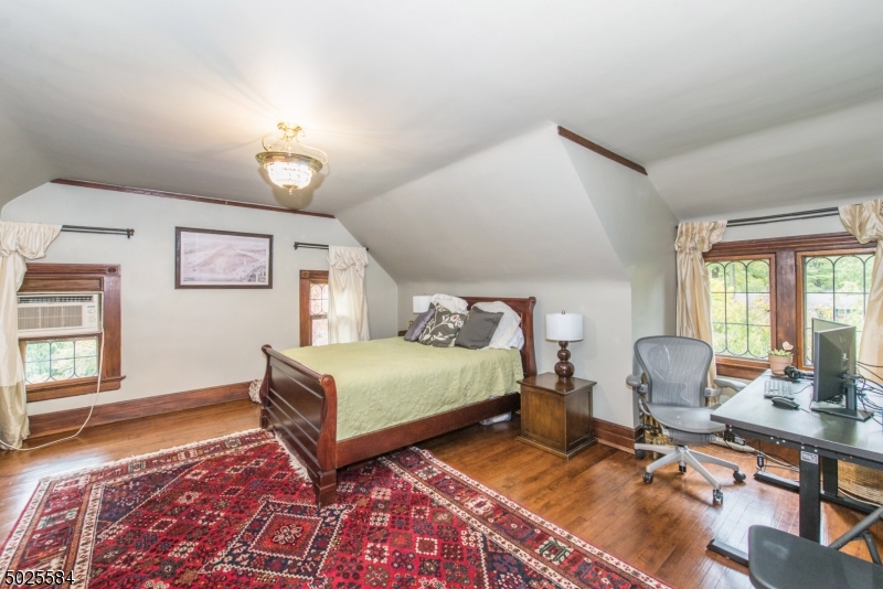 89 Ridgewood Avenue Glen Ridge, NJ 07028 - Photo 19 of 21 a bedroom with a bed and a window