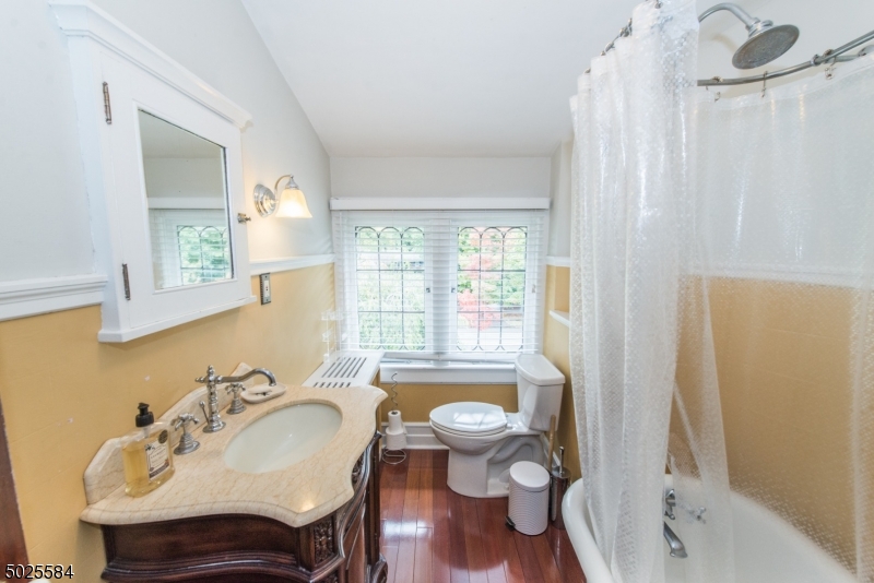 89 Ridgewood Avenue Glen Ridge, NJ 07028 - Photo 20 of 21 a bathroom with a sink toilet and shower